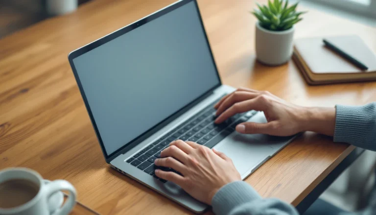 Hands typing on laptop at wooden desk with coffee and notebook in professional workspace